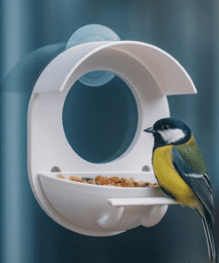Clear 3D printed window bird feeder attached to glass with birds feeding