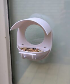 Minimalist window-mounted bird feeder with charging gap for seeds, 3D printed design